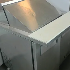 True TSSU-36-12M-B commercial refrigerated prep table. Features stainless steel construction, a top roll-back lid, white polyethylene cutting board, a