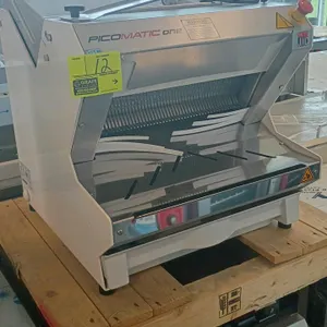 JAC Picomatic One electric automatic countertop bread slicer. Features front-loading design, integrated slicing blades, slice guide, and emergency sto