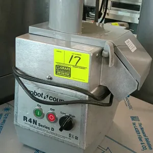 Robot Coupe R4N Series D food processor. Features a 5.5-qt. capacity base with a continuous feed vegetable prep attachment. Equipped with low and high