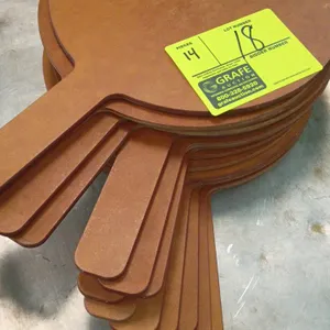 Wood pizza peels. Features a round blade and flat integral handle. Solid wood composite construction. 10" diameter blade.