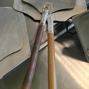 Aluminum pizza peels. Features aluminum blades secured to wooden handles with rivet attachments.