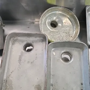 Assorted meat grinder feeder pans. Includes two rectangular pans and one round pan. Features feed openings measuring 2-3/8" and 1/2". Constructed of c