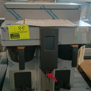 2022 FETCO CBS-2132-XTS twin station commercial coffee brewer. Features Extractor Touchscreen control, dual brew stations, and a front hot water fauce
