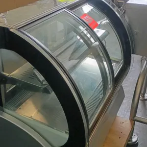 Vollrath countertop refrigerated glass display case. Features self-contained refrigeration, curved glass front, sliding glass doors, and one interior 