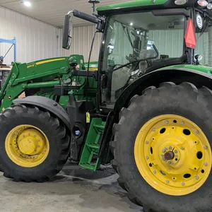 John Deere 6145R utility tractor with Front Wheel Assist (FWA). Equipped with a John Deere 660R front loader and bucket. Features an enclosed cab with