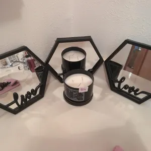 3 black mirrors and candle