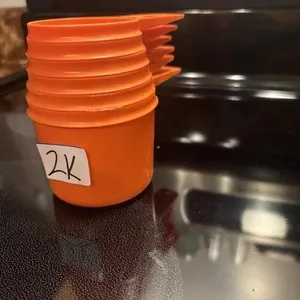 Orange Tupperware measuring cups