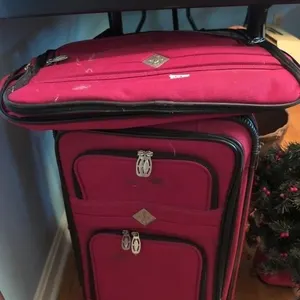 Red suitcase and duffel bag