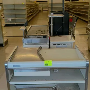 Borroughs Series 80 metal check lane. Features conveyor belt, cashier stand with woodgrain accents, and integrated bagging area. 128"L. Note: Untested