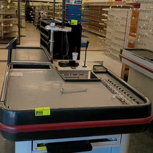 Single-belt checkout lanes. Features conveyor belt, keyboard/monitor mounting post, customer bagging area, and cash drawer compartment. Dimensions: 10