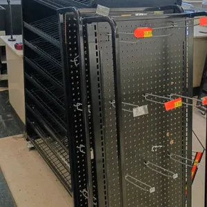 Checklane merchandisers. Features black metal construction, angled wire display shelves, and pegboard endcap panels. Dimensions: 38"x23"x55". Mounted 