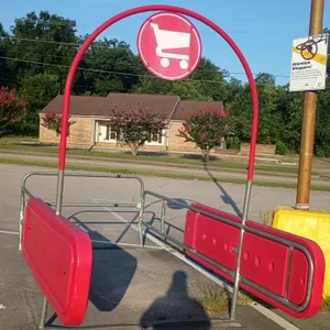 Unbranded cart corrals. Features galvanized steel tubular frames with red plastic protective side panels and an overhead signage arch displaying a sho