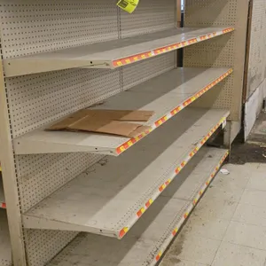 8'L of Madix wall shelving. Features beige metal construction with pegboard backing and adjustable metal shelves with price tag channels. Dimensions: 