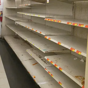 20'L of Madix wall shelving. Features beige metal uprights, pegboard backing, and adjustable shelves. Dimensions: 20'L x 22"D x 84"H. Contents not inc