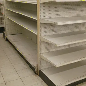 24'L of Madix gondola shelving. Features an off-white finish, 22" double-sided base shelves, and 60"H uprights with adjustable upper shelves. Contents