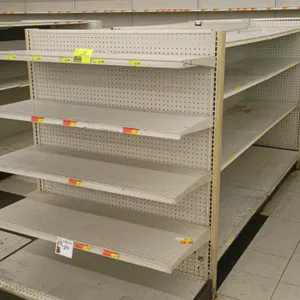 24'L of Madix gondola shelving. Features an off-white finish, 22" double-sided base shelves, 60"H uprights, and adjustable upper shelves. Contents not