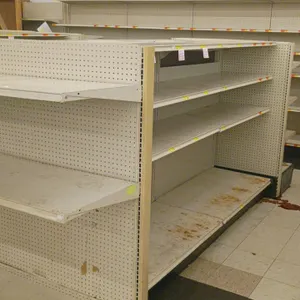 24'L of Madix gondola shelving. Features an off-white finish, 22" double-sided base shelves, and 60"H uprights with adjustable upper shelves. Contents