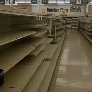 146'L of Madix gondola shelving. Features an off-white finish, 72"H uprights, and 25"/25" double-sided base shelves. Contents and aisle signage not in