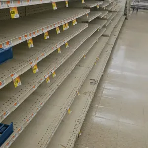128'L of Madix gondola shelving. Features an off-white finish, 72"H uprights, and 25"/25" double-sided base shelves. Contents and aisle signage not in