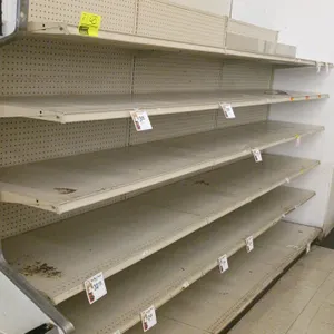 12' of Madix wall shelving. Features beige pegboard backing, 25"D base shelves, and five adjustable upper shelves. 76"H. Contents not included.