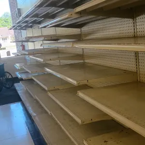 24' of Madix wall shelving. Features cream-colored metal uprights, pegboard backing, and adjustable metal shelving. Dimensions: 24'L x 25"D x 78"H. No