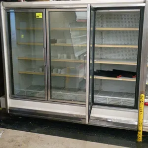 Kysor Warren IV5V1-3U 3-door frozen food display case. Features gas defrost, LED lighting, adjustable shelving, and bottom wire racks. S/N: 041034400.