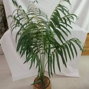 Faux plant with palm leaf pot
