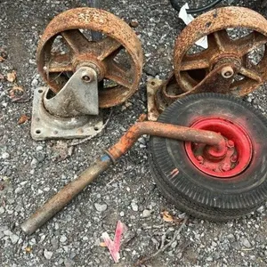 2 large cast iron casters and wheel