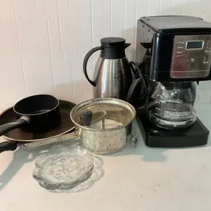 Kitchen Items Including Coffee Maker, Glass Plates, and Cookware