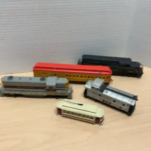 Five HO Scale Model Train Cars and Locomotives Including Erie Lackawanna, Western Maryland, and Circ
