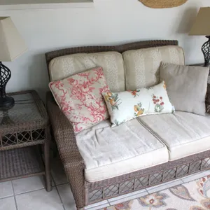 Wicker Couch with Cushions, 2 Glass-Top End-Tables, And Lamps