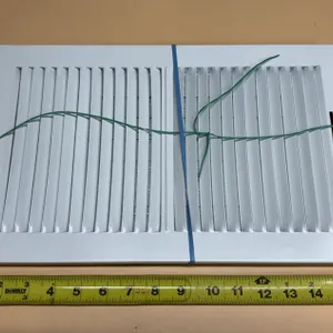 This is a 14-inch by 6-inch white steel 2-way sidewall and ceiling air register, featuring stamped l