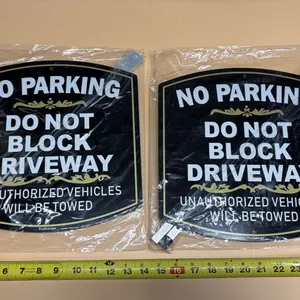 (2) Yuzkouge No Parking, Do Not Block Driveway Signs packaged with detachable mounting stakes.