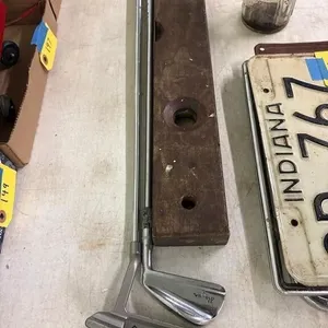 2 golf clubs and a wooden level