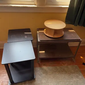 Furniture: Metal Shelf, Rotating Wooden Storage Unit, and Two Black Side Tables
