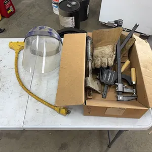Clamps, axe, face shield, and work gloves