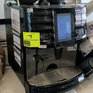 Schaerer SCAP Steam espresso machine. Features dual bean hoppers, digital touchscreen display, steam wand, hot water spout, and stainless steel drip t