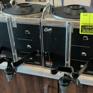 Curtis GEM-3 satellite coffee dispensers. Features stainless steel construction, sight glass volume level indicators, front dispensing faucets with pr