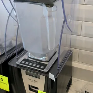 Blendtec Connoisseur 825 commercial blender. Features sound enclosure hood, digital push-button controls, and blending jar with lid.