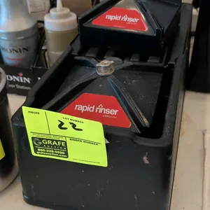 Blendtec Rapid Rinser blender container rinser station. Features dual push-down rinser modules housed in a countertop holder.