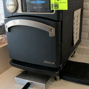 TurboChef Sota countertop rapid cook oven. Features digital touchscreen display, drop-down door, interior wire rack, and metal transfer paddle. Mounte