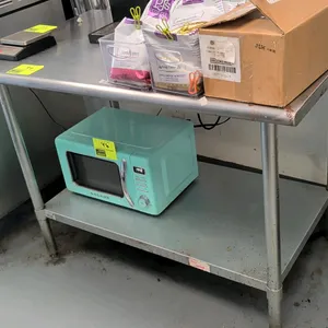 Stainless steel top work table. Features a galvanized undershelf and galvanized legs with adjustable bullet feet. 48" x 30". Contents not included.
