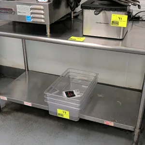 Stainless steel work table. Features a stainless steel top and stainless steel undershelf. Dimensions: 60" x 30". Mounted on tubular legs with adjusta