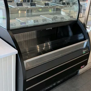 Turbo Air TOM-W-50SB-N self-contained refrigerated combination display case. Features a curved glass upper service section with rear sliding doors and