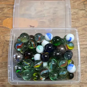Plastic bin full of various large marbles