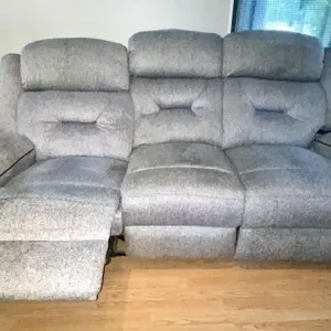 Reclining sofa with plush three-seat design and