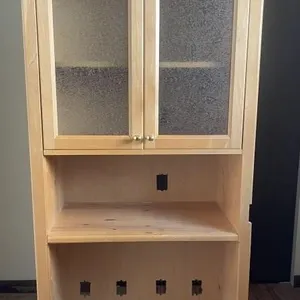 Wooden storage cabinet with textured glass doors.