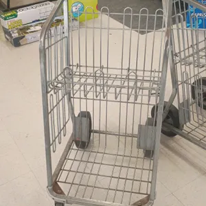 Metal parking lot grocery carryout cart. Features tubular frame, wire basket construction with an upper folding wire shelf, integrated push handle, an
