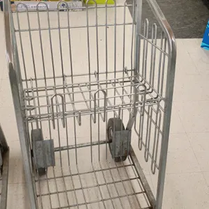 Metal grocery carryout parcel cart. Features upper folding wire shelf, lower cargo basket area, and integrated push handle. Mounted on two front swive
