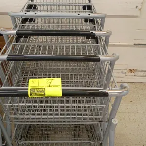 Double-decker shopping carts. Features two-tier wire basket design, black plastic handle sleeve, protective corner bumpers, and nesting frame. Mounted